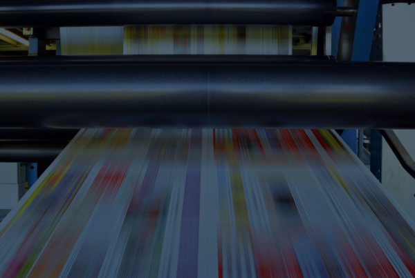 Printed retail marketing materials moving through a production press